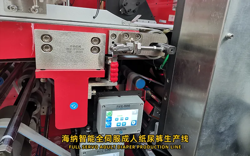 Adult diaper production line with wide material paths and guarded process modules